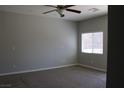 Comfortable bedroom with carpet, ceiling fan, and a window that provides natural light at 9065 Mastodon Ave, Las Vegas, NV 89149