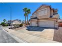 Two-story home with three-car garage, desert landscaping, and well-maintained surroundings at 98 Milicity Rd, Henderson, NV 89012