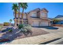 Inviting two-story home with manicured landscaping, rock groundcover and a charming side yard at 98 Milicity Rd, Henderson, NV 89012