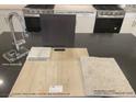 New kitchen samples display luxury vinyl plank flooring, quartz countertops, upgraded cabinets, and upgraded carpet at 9912 Landings St, Las Vegas, NV 89141