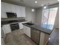 Bright kitchen featuring stainless steel appliances, a central island, granite countertops, and white cabinets at 10449 Forked Run St, Las Vegas, NV 89178