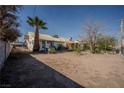 Spacious backyard with mature trees and desert landscaping, offering a blank canvas for customization at 1213 New Mexico St, Boulder City, NV 89005