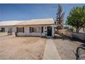Inviting single-story home with sidewalk leading to the front door and simple desert landscaping at 1213 New Mexico St, Boulder City, NV 89005