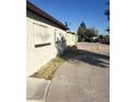 Long driveway leads to the back of the beige house with security bars over windows at 1936 Lawry Ave, North Las Vegas, NV 89032