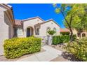 Charming single-story home featuring a gated entrance and mature landscaping at 2131 Sandstone Cliffs Dr, Henderson, NV 89044