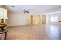 Open-concept living room features neutral walls and tile flooring throughout at 2131 Sandstone Cliffs Dr, Henderson, NV 89044