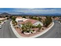 Expansive aerial shot showcases this home's location with mountain views and landscaped surroundings in a residential neighborhood at 2524 Banora Point Dr, Las Vegas, NV 89134
