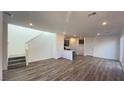 Bright, open-concept living space with wood floors, recessed lighting, and staircase at 2713 Abrantes Pl, Henderson, NV 89044