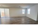 Open living space with natural light, wood floors, and sliding door to patio at 2713 Abrantes Pl, Henderson, NV 89044