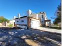 Two-story home with a large garage, balcony and large yard in need of landscaping at 2784 Belcastro St, Las Vegas, NV 89117