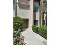 Exterior view of a well-maintained condo with fresh landscaping in front at 3412 Townhouse Dr, Las Vegas, NV 89121