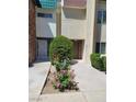 Exterior view of a well-maintained condo with fresh landscaping in front at 3412 Townhouse Dr, Las Vegas, NV 89121