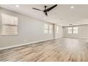 Spacious living room featuring hardwood floors, recessed lighting, and a modern ceiling fan at 3437 Visionary Bay Ave, North Las Vegas, NV 89081