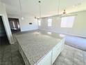 Open-concept kitchen featuring an oversized island with granite countertop and pendant lighting at 3708 Fuselier Dr, North Las Vegas, NV 89032