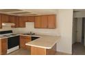 Traditional kitchen with wood cabinets, white appliances, and a breakfast bar at 4300 N Lamont St # 232, Las Vegas, NV 89115