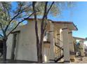 Charming exterior of a multi-unit dwelling with stucco and covered stairways for access to units at 4451 Rich Dr # D, Las Vegas, NV 89102