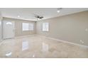 Spacious living room featuring neutral walls, ceiling fan, and marble tile flooring at 4676 E Alexander Rd, Las Vegas, NV 89115