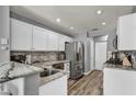 Updated kitchen featuring stainless steel appliances, granite countertops, and modern backsplash at 5024 Starfinder Ave, Las Vegas, NV 89108