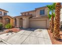 Traditional two-story home with a two-car garage, desert landscaping and palm trees at 5402 Shady Lair Ct, North Las Vegas, NV 89031