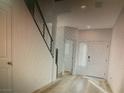 Bright entryway with light wood floors and modern railing leading to the upper level of the home at 5888 Becklow Gardens Ave, Las Vegas, NV 89141