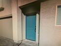 Inviting entrance showcases a bright blue front door and welcome mat, set within a modern facade at 5888 Becklow Gardens Ave, Las Vegas, NV 89141