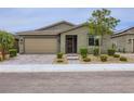 Lovely single-story home with well-maintained landscaping, a two-car garage, and a paved driveway and walkway at 6519 Summershade St, North Las Vegas, NV 89086