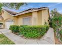 Attractive single-story home showcasing lush green bushes, a well-manicured lawn, and a sidewalk at 6529 Sierra Diablo Ave, Las Vegas, NV 89130