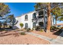 Condominium exterior featuring the building's design and surrounding landscape with sidewalk at 700 Carnegie St # 122, Henderson, NV 89052