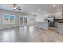 Spacious living room features tile floors, recessed lighting, and a large glass slider leading to the exterior at 7432 Red Plumeria Ave, Las Vegas, NV 89113