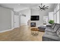 Open living room with a fireplace, tile flooring, and neutral paint for a modern touch at 7713 White Grass Ave, Las Vegas, NV 89131