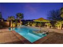 Inviting backyard pool with a lounge chair and pristine desert landscaping at 8 Reflection Cove Dr, Henderson, NV 89011