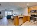 Modern kitchen featuring stainless steel appliances, granite countertops, and an adjacent dining area at 8255 Las Vegas S Blvd # 1414, Las Vegas, NV 89123