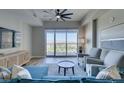 Bright living room featuring a sectional sofa, a stylish ceiling fan, and large windows with views at 8255 Las Vegas S Blvd # 1414, Las Vegas, NV 89123