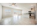 Spacious living room with tiled floor, modern lighting and sliding door to yard at 8278 Palladium St, Las Vegas, NV 89113