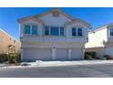 Charming two-story townhouse with three-car garage and desert landscaping at 8843 Tomnitz Ave # 102, Las Vegas, NV 89178