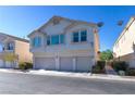 Charming two-story townhouse with three-car garage and desert landscaping at 8843 Tomnitz Ave # 102, Las Vegas, NV 89178
