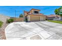 View of the house with an expansive concrete driveway, lawn, and a three-car garage for ample parking at 8914 Termoli St, Las Vegas, NV 89123
