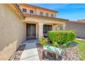 Charming front entrance with a stone bench and manicured bushes leading to the ornate front door at 8914 Termoli St, Las Vegas, NV 89123