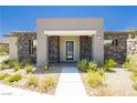Inviting front facade featuring stone accents, neutral stucco, and desert landscaping at 901 Allister Fields Ln, Las Vegas, NV 89138