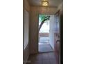 A tiled entryway showcases the front door, complemented by a window and neutral paint at 994 River Walk Ct, Henderson, NV 89015