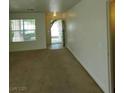 The bright living room features neutral paint, a window and access to the front door at 994 River Walk Ct, Henderson, NV 89015