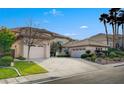 Spacious home featuring a three-car garage, well-maintained landscaping, and a circular driveway at 10829 Ickworth Ct, Las Vegas, NV 89135