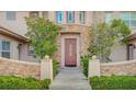 Inviting entryway showcasing a beautiful front door, stone accents, and manicured greenery at 10829 Ickworth Ct, Las Vegas, NV 89135