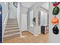 Inviting entryway with tile flooring, staircase, and decoratively adorned walls at 11023 Ketchikan St, Las Vegas, NV 89179