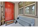 Welcoming front porch with a vibrant red door, bench seating, and a 'Welcome' mat at 11023 Ketchikan St, Las Vegas, NV 89179