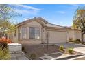 Well-maintained single-story home featuring a two-car garage and desert landscaping, providing curb appeal at 11076 Zampino St, Las Vegas, NV 89141