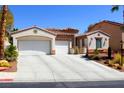 Charming single-story home featuring a three-car garage, desert landscaping, and tile roof at 11240 Romette Ct, Las Vegas, NV 89141
