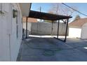 A view of the spacious backyard with a covered patio and block wall at 1316 Lawry Ave, Las Vegas, NV 89106