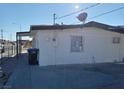 Exterior view of a home with a side yard and black waste container at 1316 Lawry Ave, Las Vegas, NV 89106