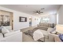 Bright living room with modern decor, a large sectional sofa, and an open layout for seamless entertaining at 187 Palm Fox Ct, Henderson, NV 89011